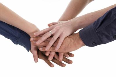 business people holding hands on a white background