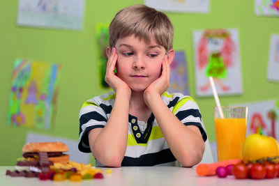 39791012 - boy having choice - healthy or unhealthy lunch