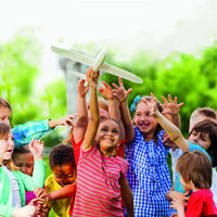 Close-up view of kids reaching after airplane toy