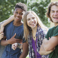 Multiracial group of teenagers handing out outdoors