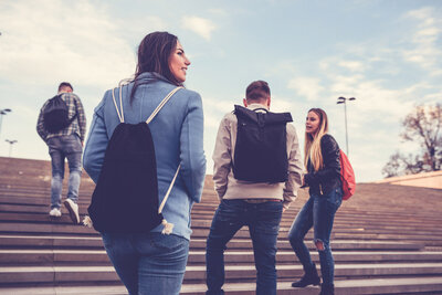 Group of Students with Backpacks Walking to School